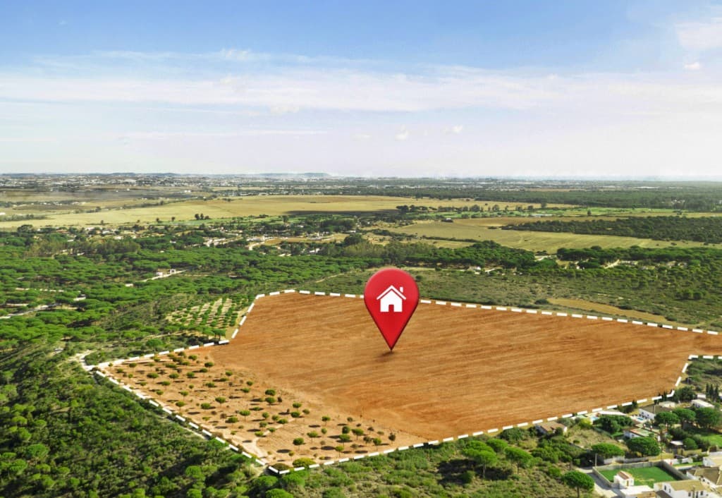 Aerial view of a marked land parcel with a location pin