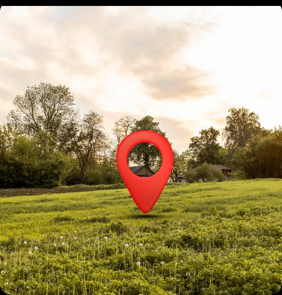 Green field marked with a red location pin